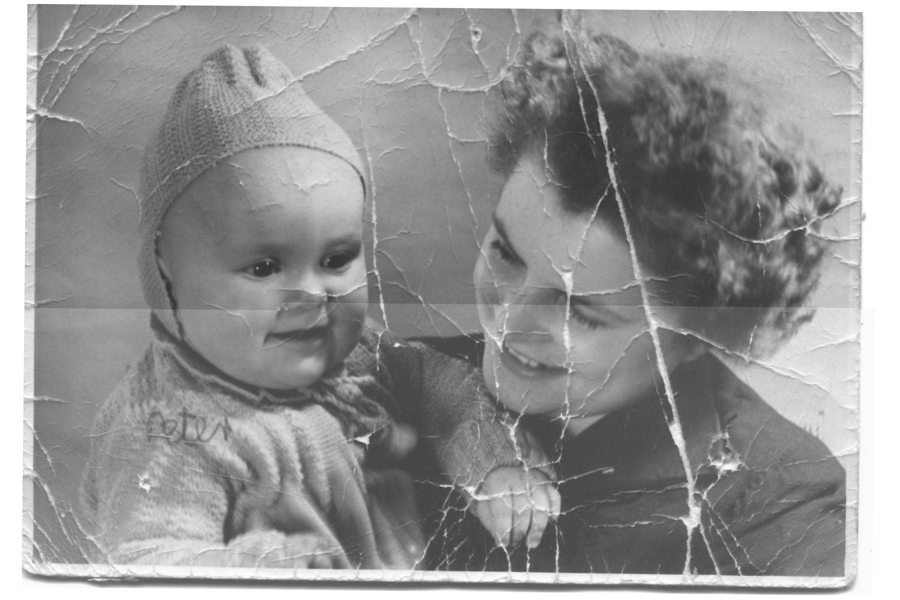 the screens transition from a damaged older black and white photo to a restored color phot. Some images have tears and rips that go away with the restoration.