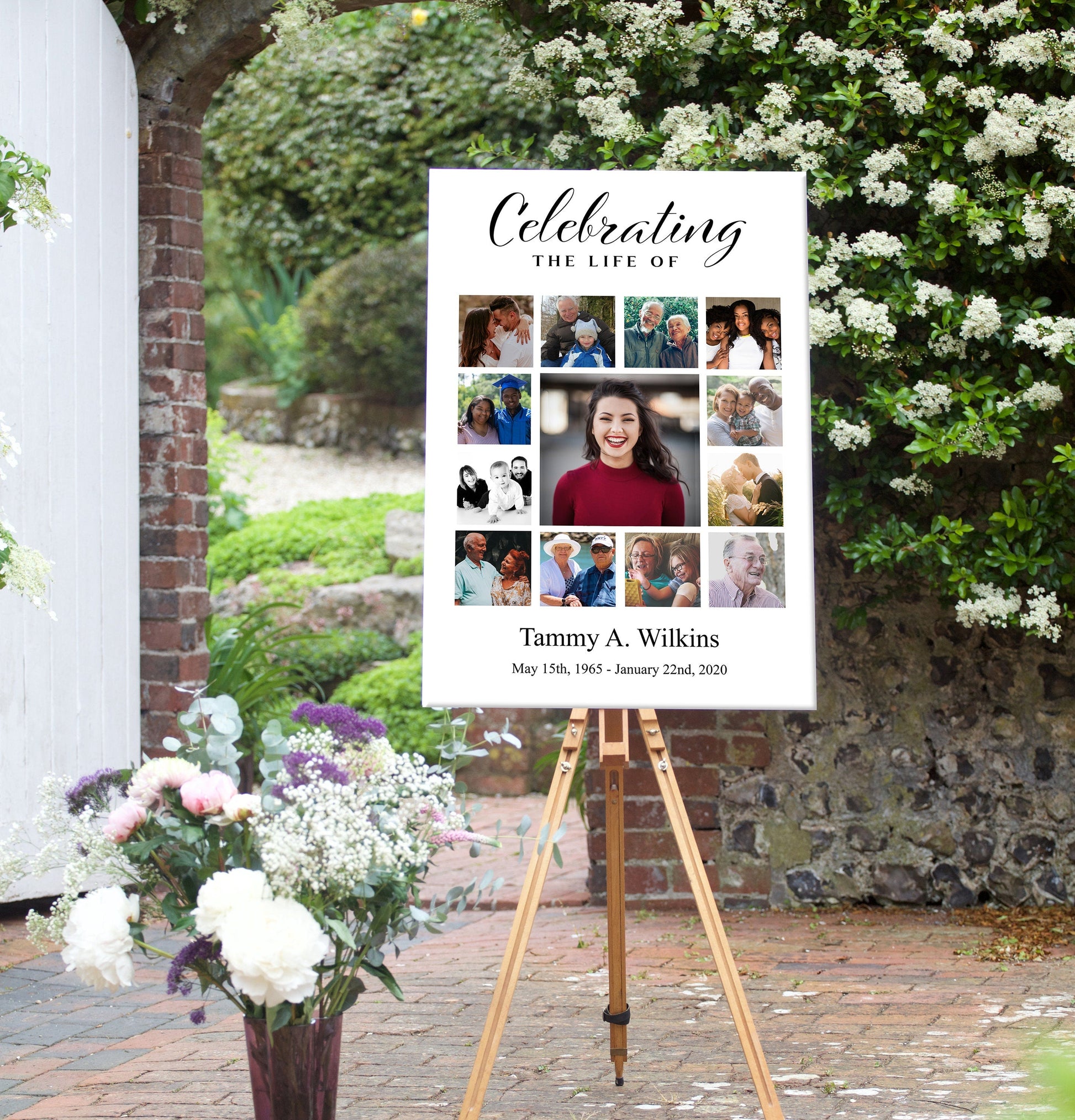 A funeral poster sits outside next to some flowers sitting on an easel. This funeral poster has a photo collage in the center. 