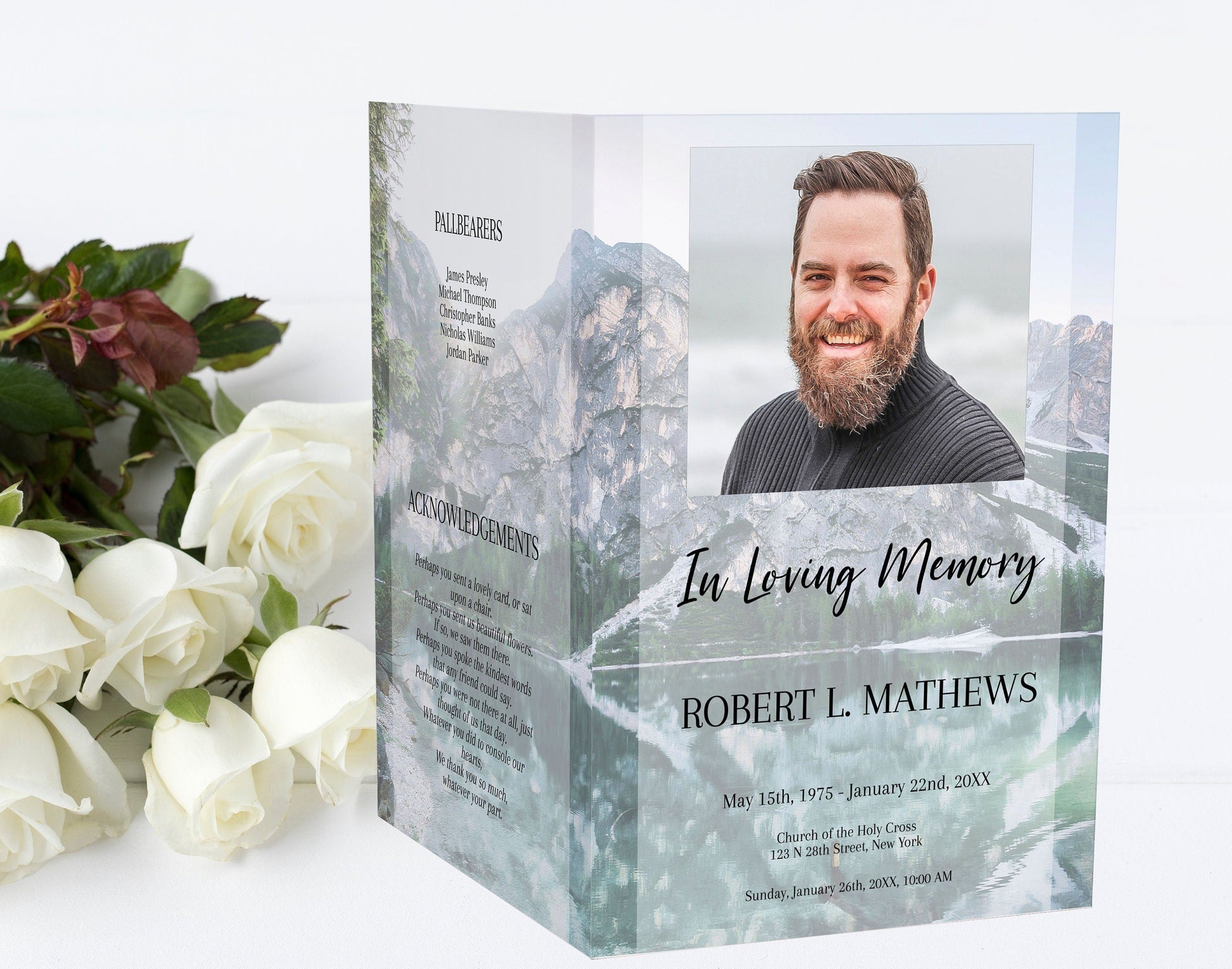 funeral program front and back page standing upright with flowers beside