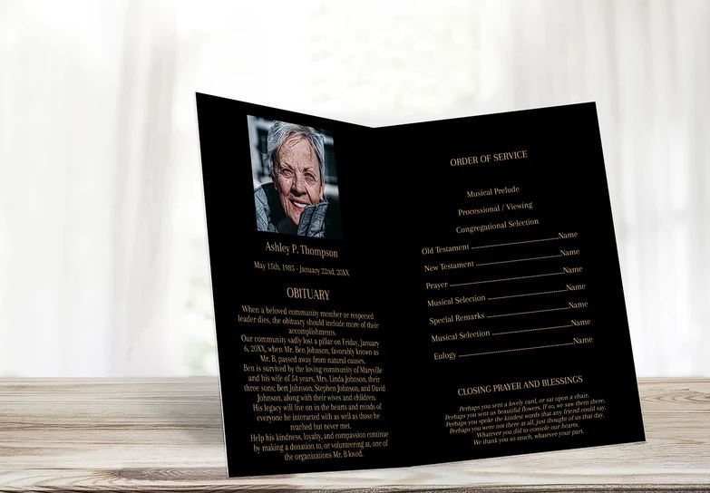 Inside a funeral program template with a black background and gold text can be seen a photo above an obituary section adjacent to the order of service section.